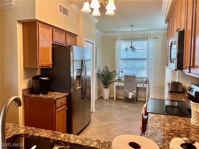 kitchen featuring light tile patterned flooring, ornamental molding, stainless steel appliances, pendant lighting, and an inviting chandelier