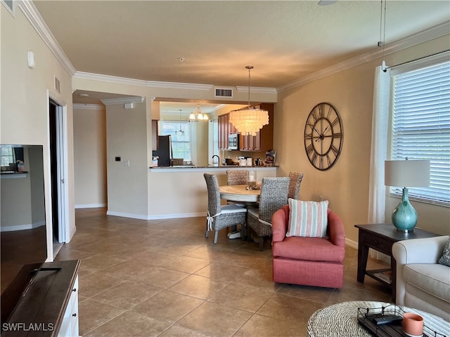 tiled living room with plenty of natural light, a chandelier, and crown molding