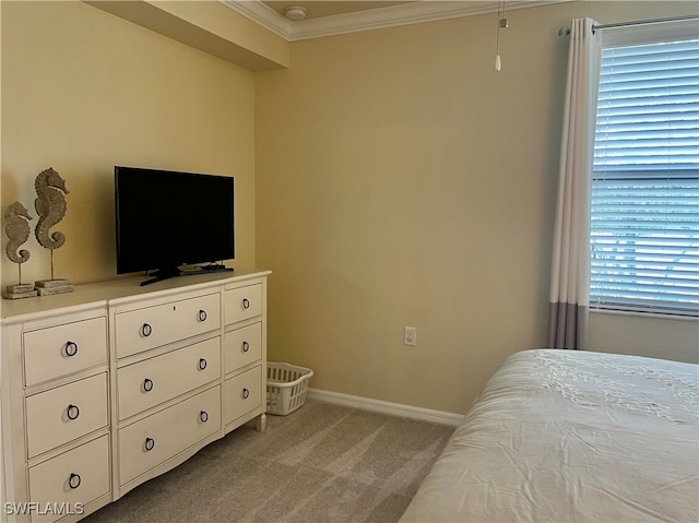 carpeted bedroom featuring multiple windows and ornamental molding