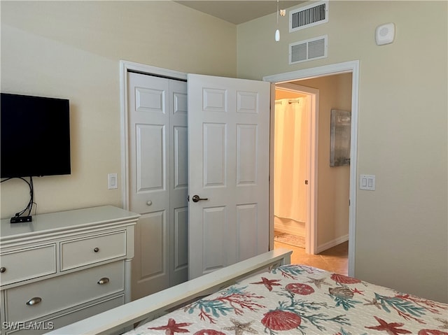 bedroom with light tile patterned flooring and a closet