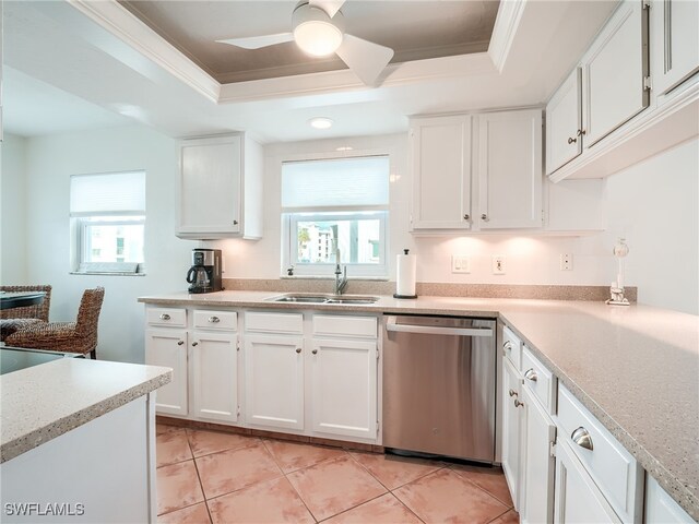 kitchen featuring white cabinets, dishwasher, a raised ceiling, and a healthy amount of sunlight