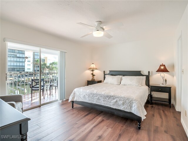 bedroom featuring access to outside, hardwood / wood-style flooring, and ceiling fan