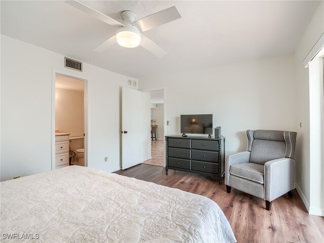 bedroom featuring connected bathroom, ceiling fan, and dark wood-type flooring