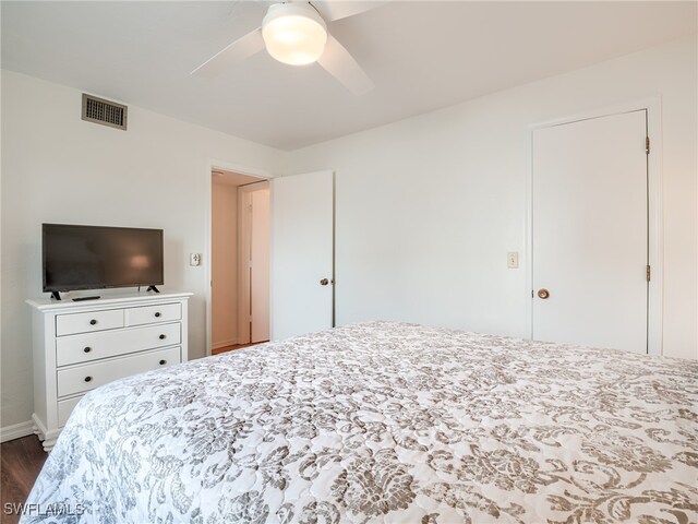 bedroom with ceiling fan and dark hardwood / wood-style flooring