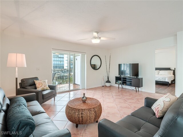 living room with ceiling fan and light tile patterned flooring