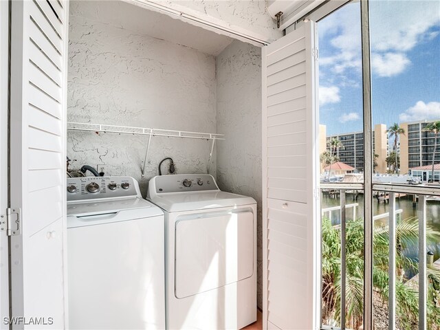 clothes washing area featuring separate washer and dryer