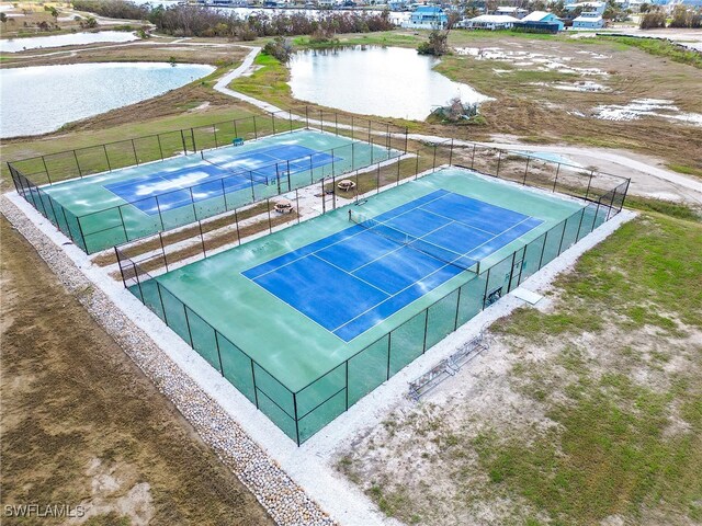 view of sport court with a water view