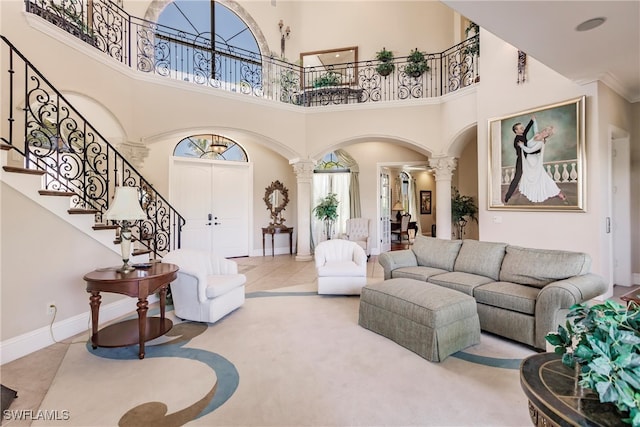 tiled living room with a high ceiling and ornate columns