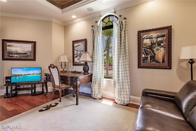 living area with hardwood / wood-style floors and crown molding