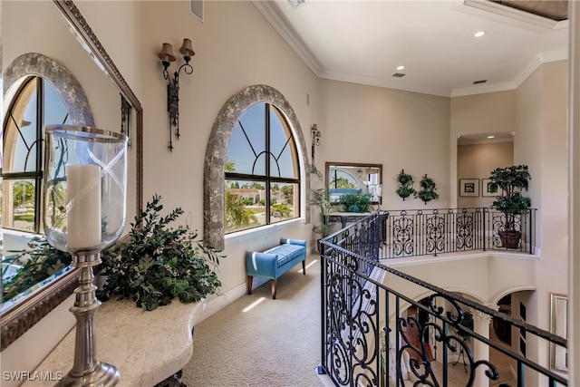 corridor featuring carpet floors and crown molding