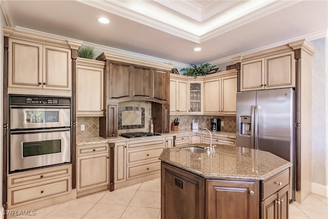 kitchen featuring stainless steel appliances, sink, light tile patterned floors, a kitchen island with sink, and crown molding