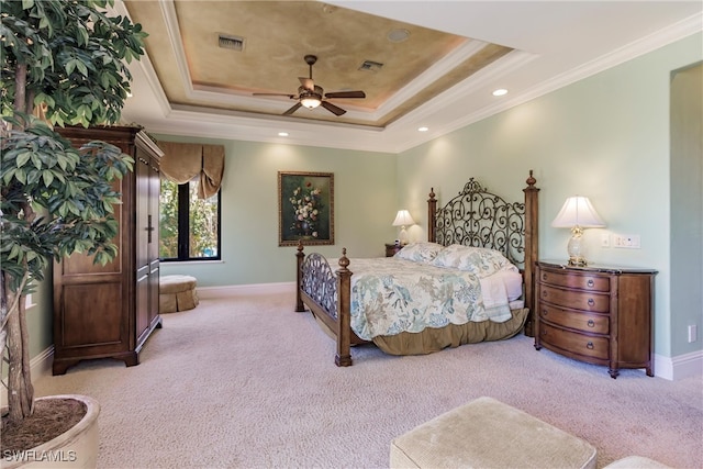 carpeted bedroom featuring ornamental molding, ceiling fan, and a raised ceiling