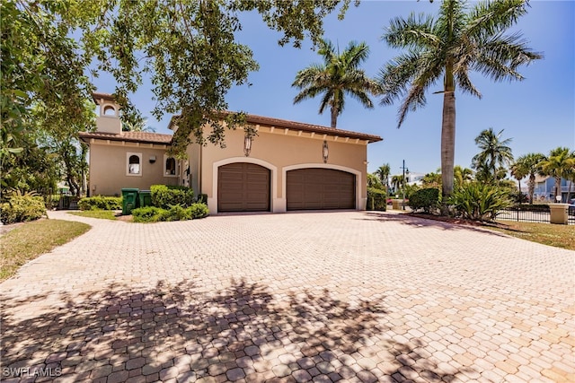 mediterranean / spanish-style home featuring a garage