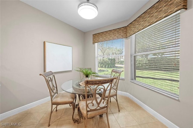 dining room with light tile patterned floors and baseboards