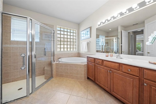 bathroom with tile patterned floors, a stall shower, connected bathroom, vanity, and a bath