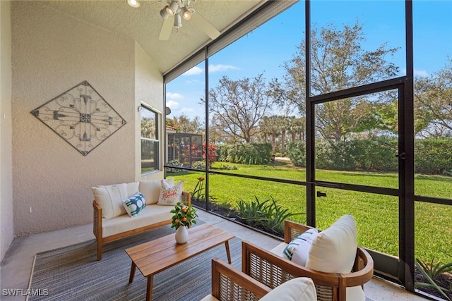 sunroom featuring a ceiling fan and vaulted ceiling