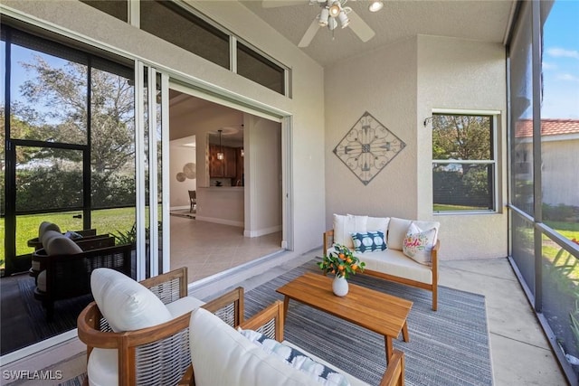 sunroom / solarium featuring a ceiling fan