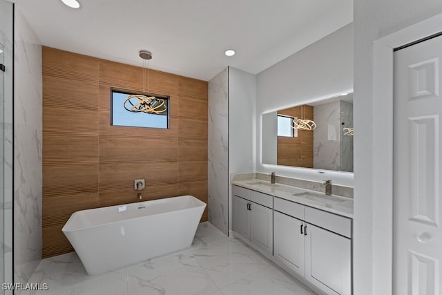 bathroom with vanity and shower with separate bathtub