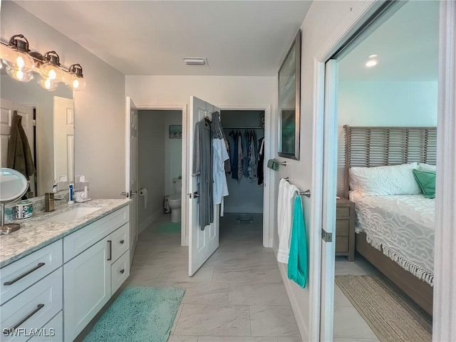 bathroom featuring vanity and toilet