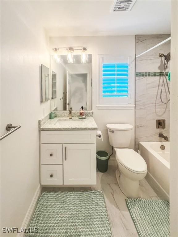 full bathroom with vanity, toilet, and tiled shower / bath combo