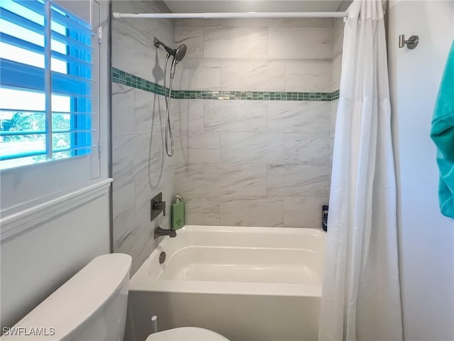 bathroom featuring shower / bath combination with curtain and toilet