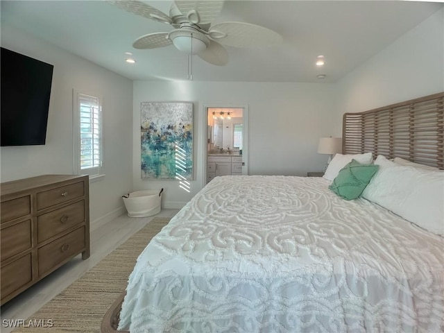 bedroom featuring connected bathroom, light hardwood / wood-style floors, and ceiling fan