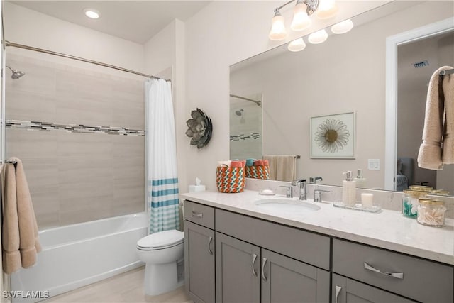 full bathroom featuring tile patterned floors, vanity, toilet, and shower / bathtub combination with curtain