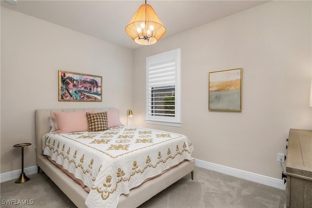 bedroom featuring carpet and a chandelier