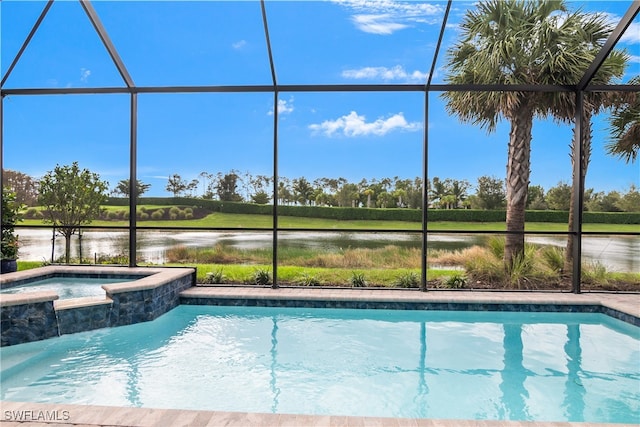 view of pool with glass enclosure, a water view, and an in ground hot tub