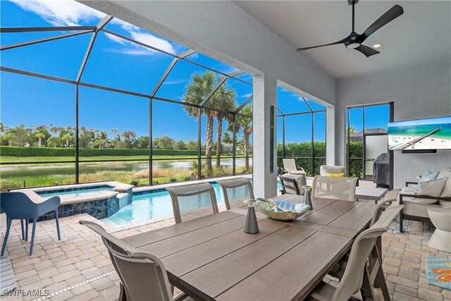 view of patio with ceiling fan, a pool with hot tub, and glass enclosure