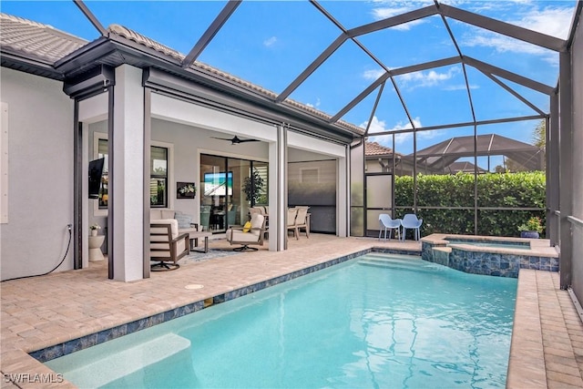 view of pool featuring ceiling fan, a patio area, an in ground hot tub, and glass enclosure