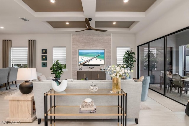 living room with beamed ceiling, ceiling fan, and coffered ceiling