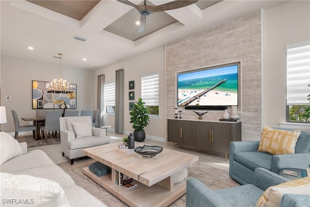 living room with ceiling fan with notable chandelier, plenty of natural light, and coffered ceiling