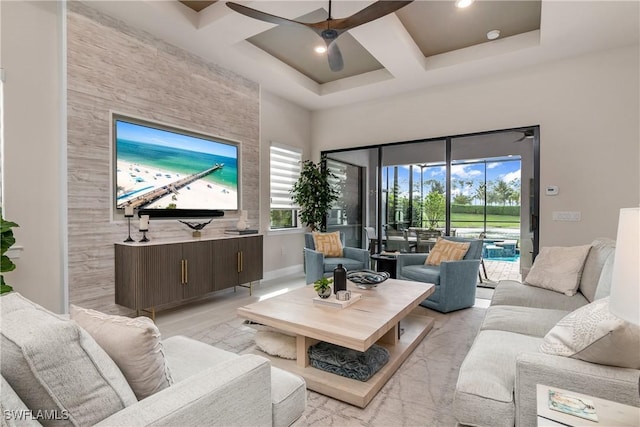 living room with ceiling fan and coffered ceiling