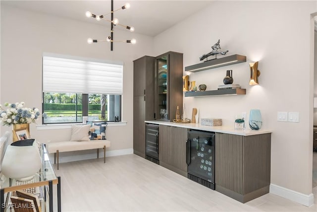 bar featuring dark brown cabinetry and wine cooler