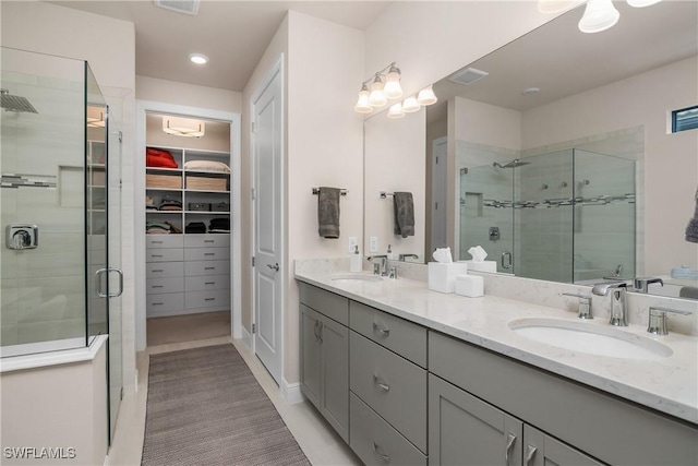 bathroom with tile patterned floors, vanity, and an enclosed shower