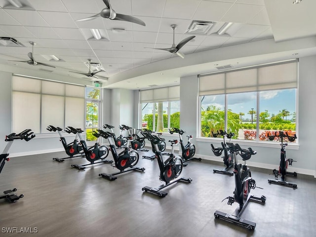 workout area with a paneled ceiling and ceiling fan