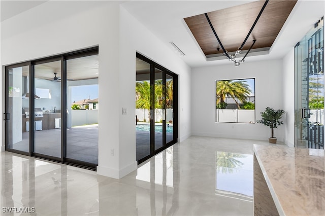 doorway to outside with french doors, a tray ceiling, a wealth of natural light, and wood ceiling