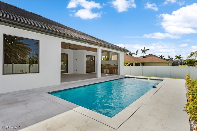 view of pool with ceiling fan and a patio