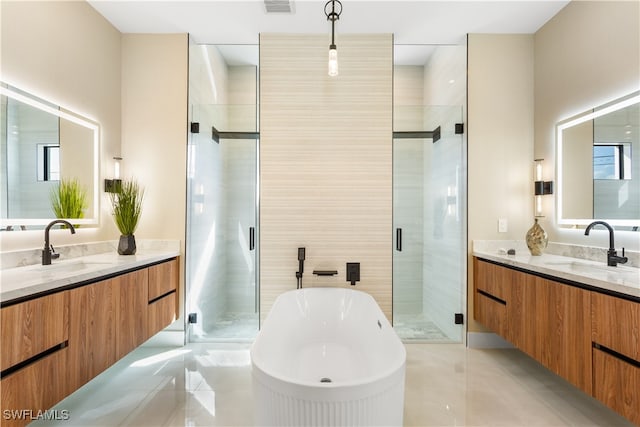 bathroom featuring vanity and independent shower and bath