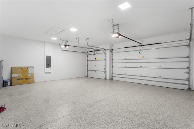 garage with electric panel and a garage door opener