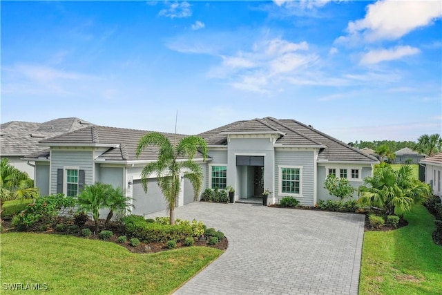 view of front of house with a front yard and a garage