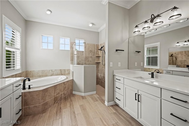 bathroom featuring hardwood / wood-style floors, vanity, crown molding, and independent shower and bath