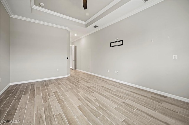 unfurnished room with light hardwood / wood-style floors, a raised ceiling, ceiling fan, and ornamental molding