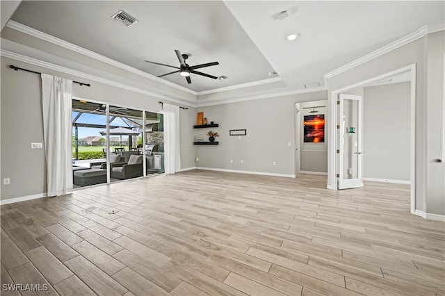 spare room featuring a raised ceiling, ceiling fan, and crown molding