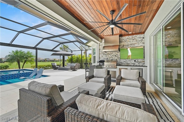 view of patio / terrace with an outdoor kitchen, an outdoor hangout area, a lanai, an in ground hot tub, and a grill