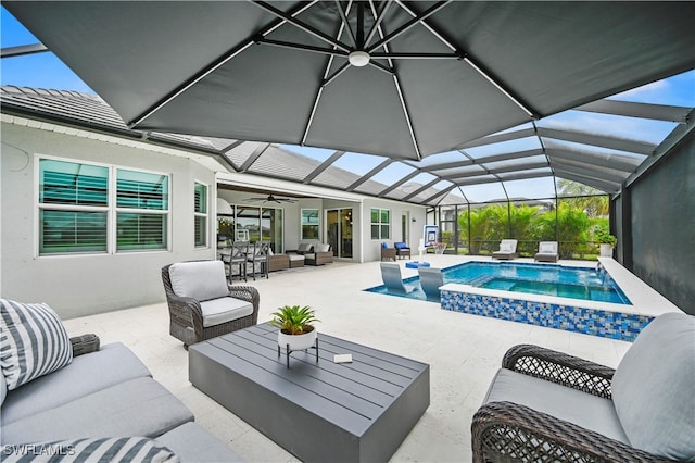 view of pool featuring outdoor lounge area, ceiling fan, glass enclosure, an in ground hot tub, and a patio