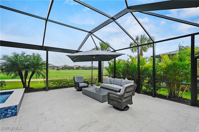 view of patio / terrace featuring an outdoor living space and a lanai