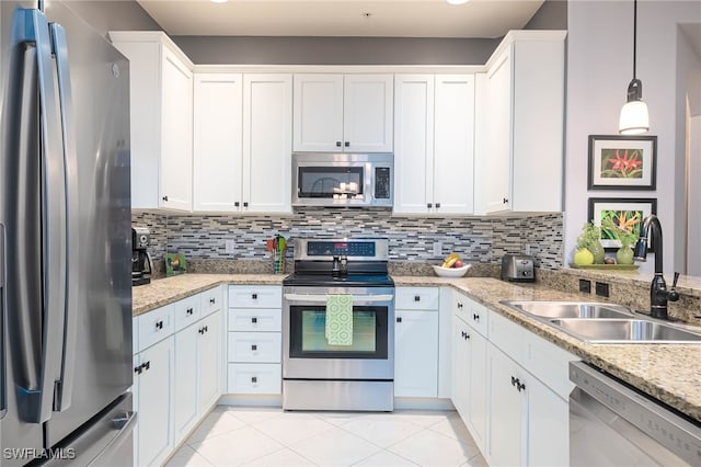 kitchen featuring white cabinets, appliances with stainless steel finishes, hanging light fixtures, and sink