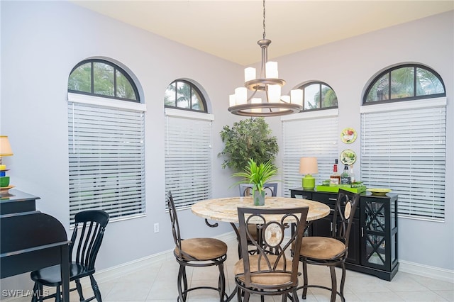 dining space featuring a notable chandelier and light tile patterned floors